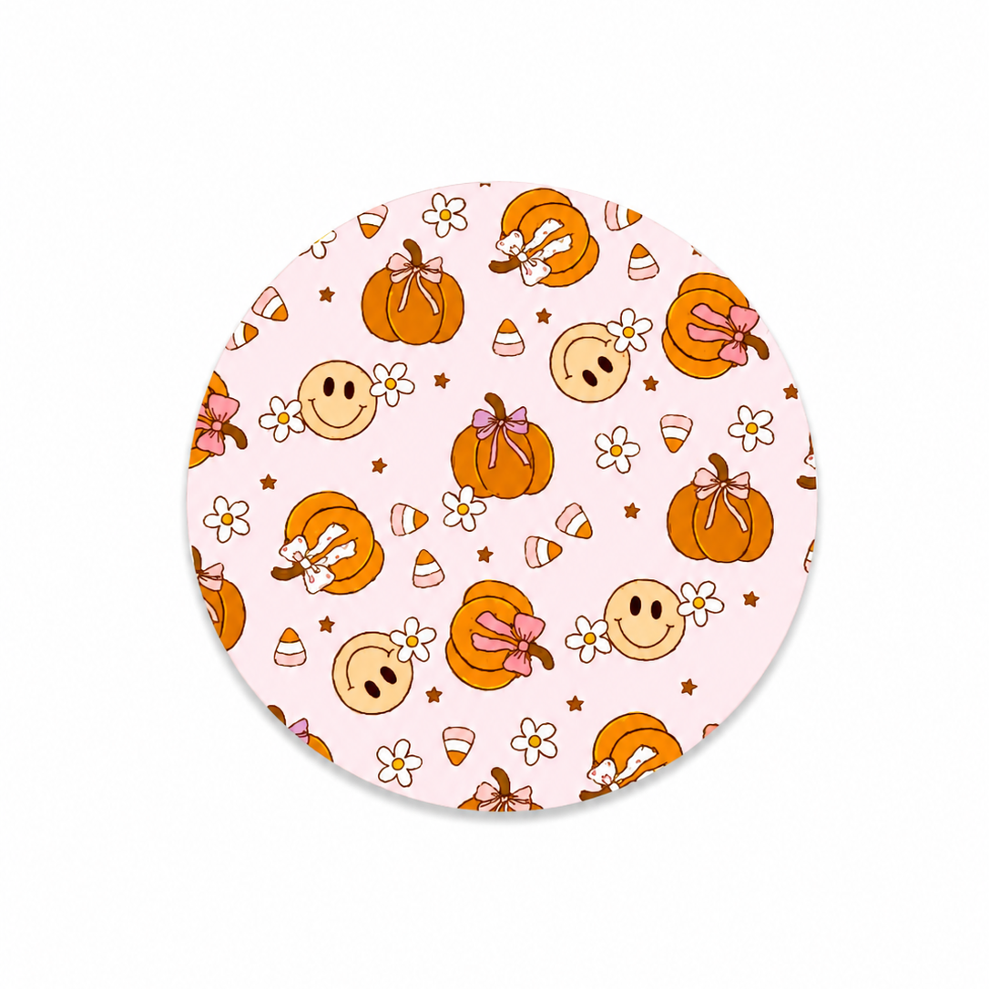 Pink pumpkin smile hard board add-on featuring smiling pumpkins, pink bows, candy corn, daisies, and stars, compatible with interchangeable badge reel bases.