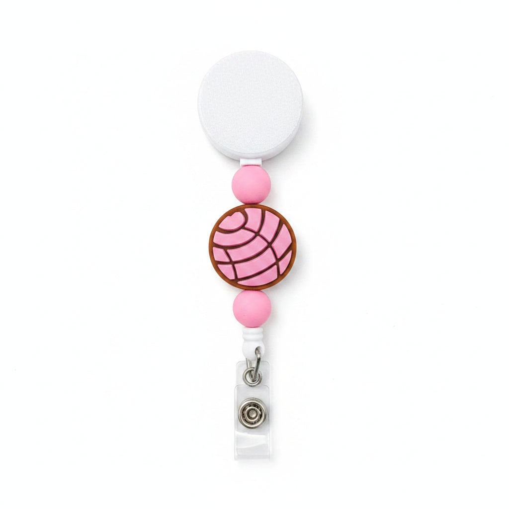 Concha interchangeable badge reel featuring pink silicone beads and a pink Mexican pan dulce concha design on a retractable beaded badge reel.