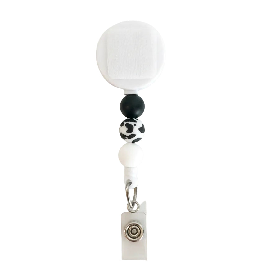 Cow Print Interchangeable Badge Reel featuring black, white, and cow print silicone beads with a retractable badge holder for nurses, teachers, veterinary professionals, and office staff.