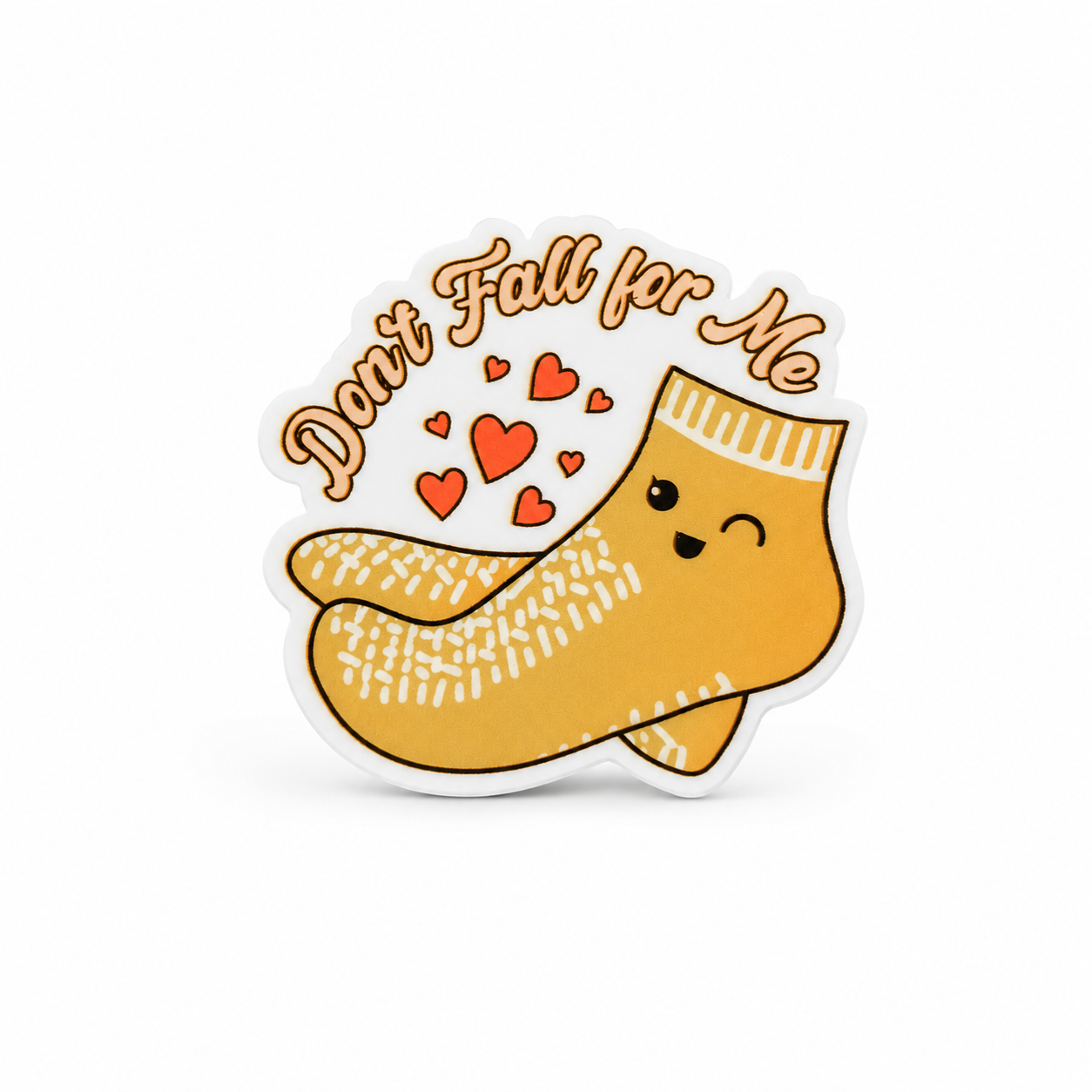 Don’t Fall for Me plastic add-on with smiling mustard-yellow socks and red hearts, compatible with interchangeable badge reel bases.