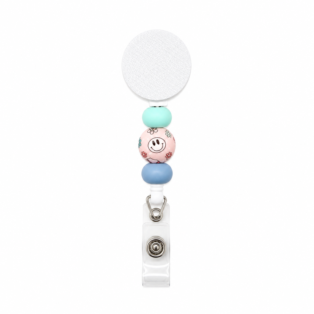 Floral smiley face badge reel with mint green and dusty blue silicone beads on a white retractable interchangeable beaded badge reel.
