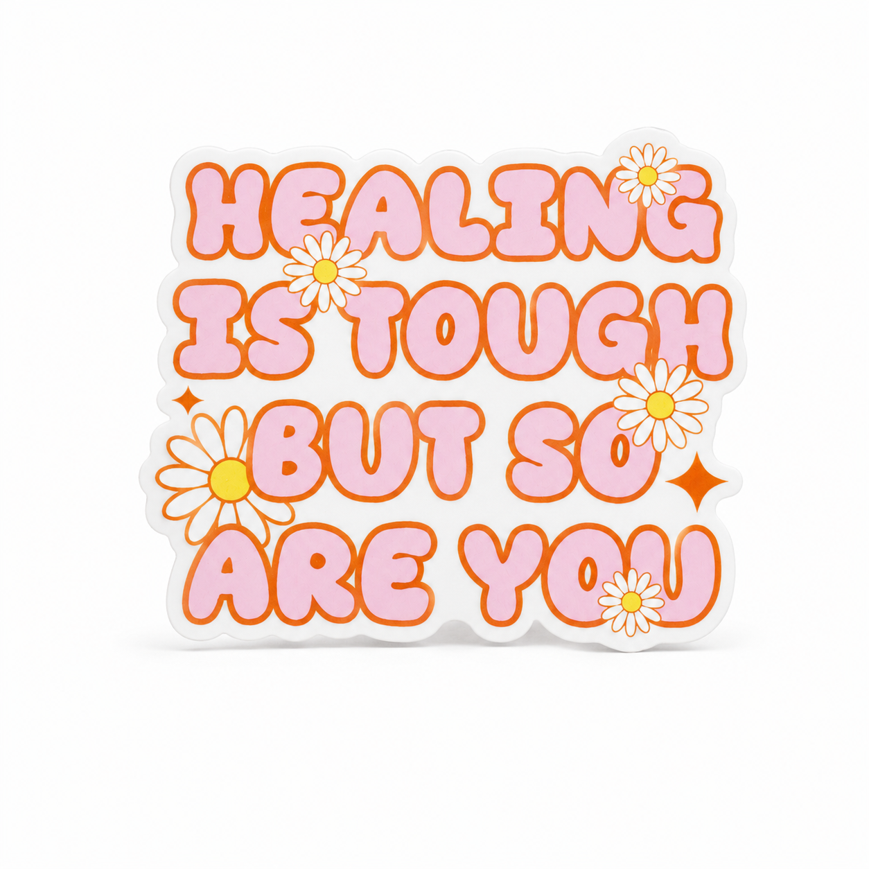 HEALING IS TOUGH BUT SO ARE YOU plastic add-on featuring pastel lettering and daisy flowers, compatible with interchangeable badge reel bases, inspirational mental health accessory and motivational badge topper.