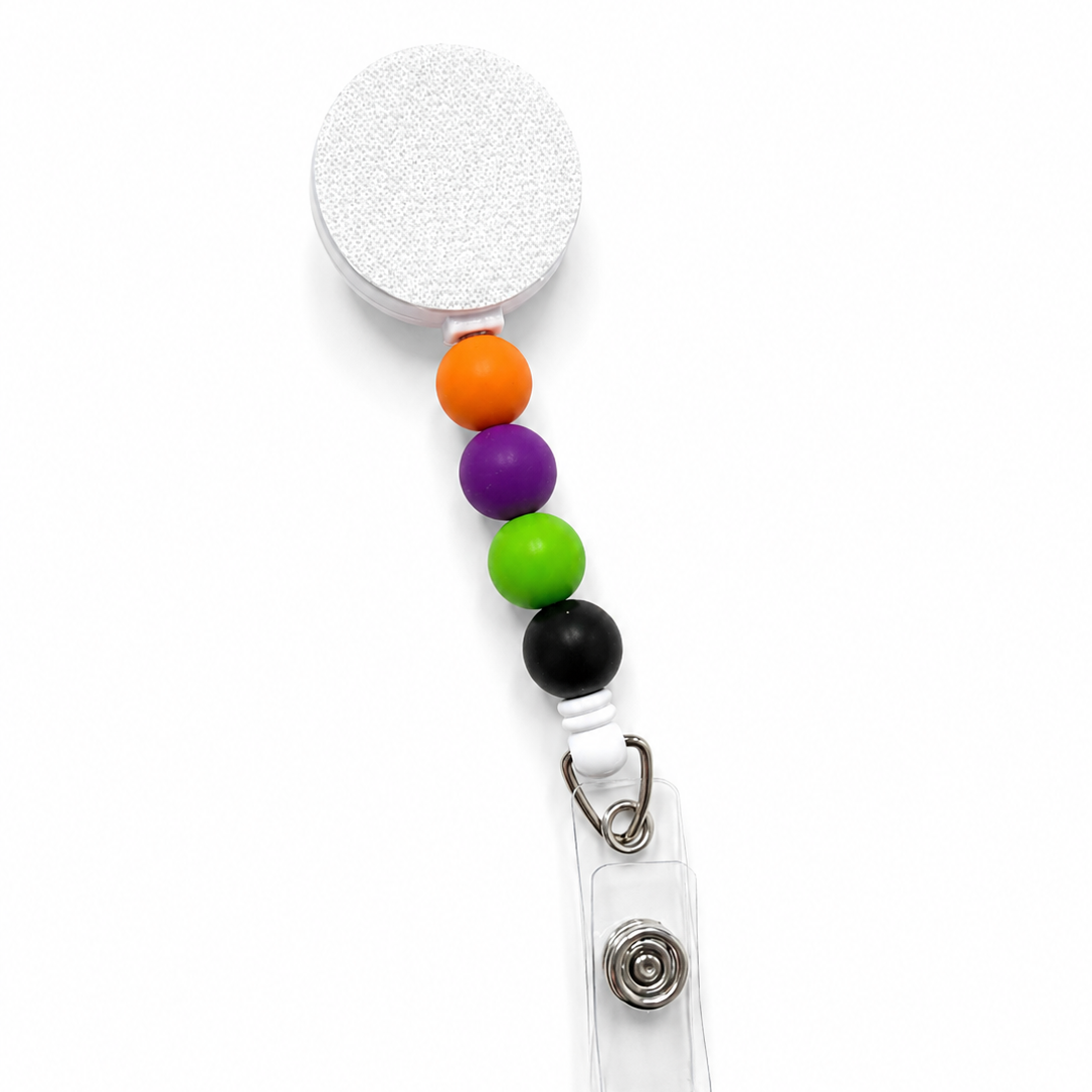 Halloween Color Pop badge reel featuring orange, purple, lime green, and black decorative beads with a retractable badge reel and secure badge holder attachment.