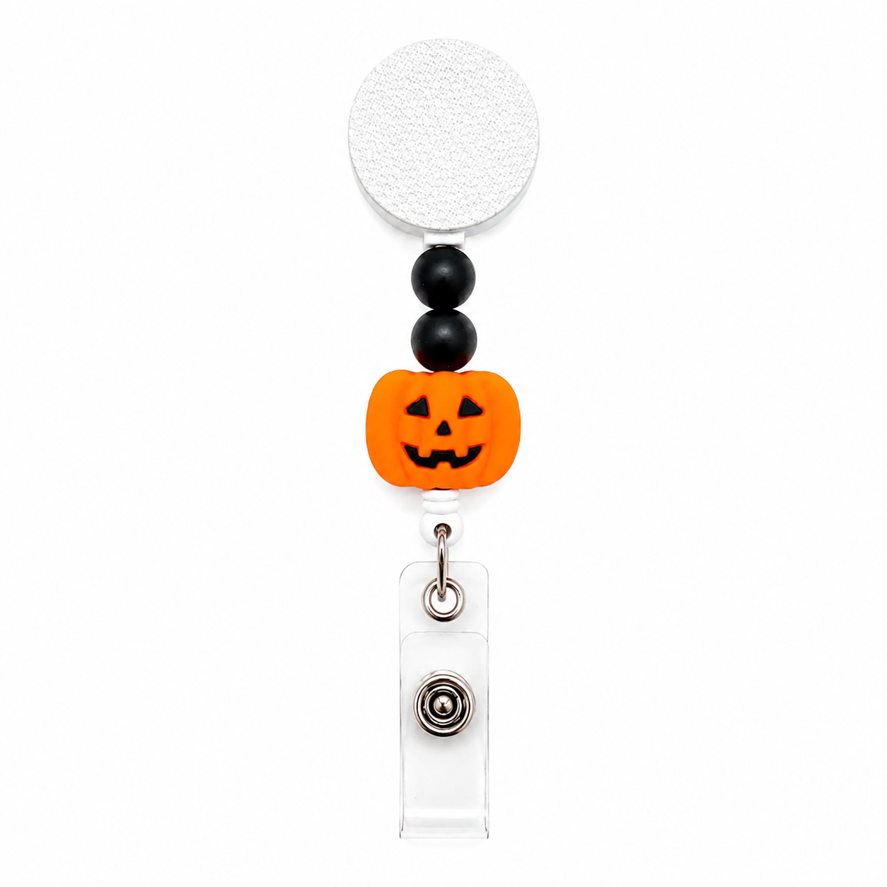 Jack-o'-Lantern badge reel featuring a smiling orange pumpkin with black decorative beads, retractable badge reel, and secure badge holder attachment for Halloween workwear.