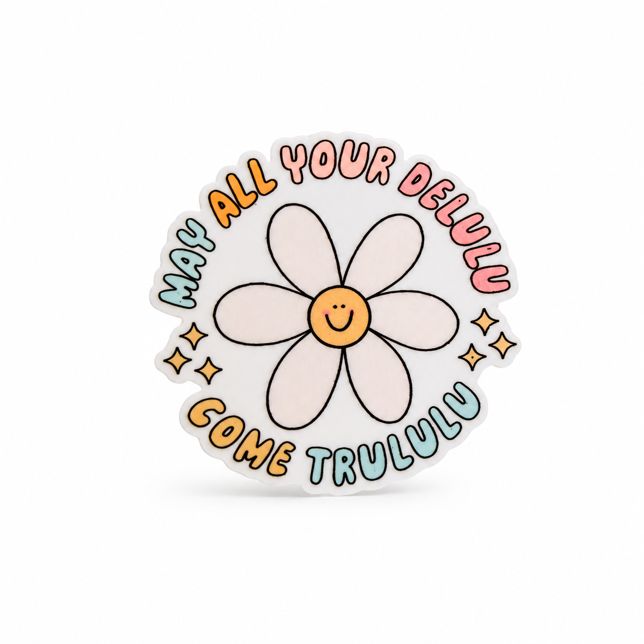 MAY ALL YOUR DELULU COME TRULULU plastic add-on with a smiling white daisy, pastel lettering, and sparkles, compatible with interchangeable badge reel bases.