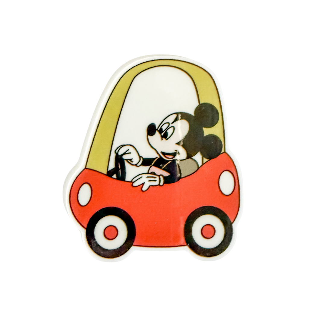 Mickey Mouse driving a red car plastic add-on compatible with interchangeable badge reel bases, featuring a cute cartoon character design.