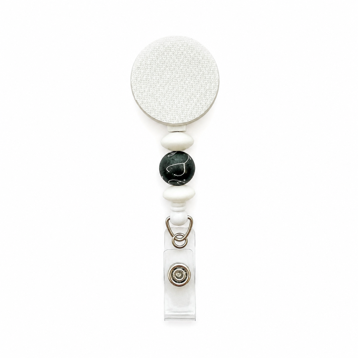 Minimalist stethoscope beaded badge reel with white silicone beads and a black decorative bead featuring a white stethoscope pattern on a white retractable badge reel.