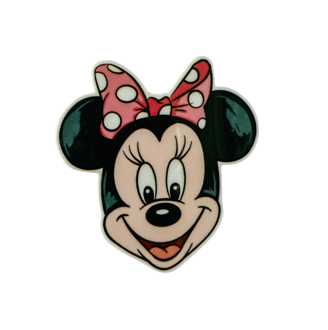 Minnie Mouse inspired plastic add-on with a smiling mouse face and pink polka dot bow, compatible with interchangeable badge reel bases.