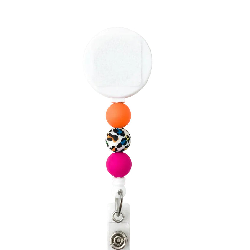 Neon leopard beaded badge reel with white retractable reel, bright orange, colorful leopard print, and hot pink silicone beads for a stylish work badge accessory.