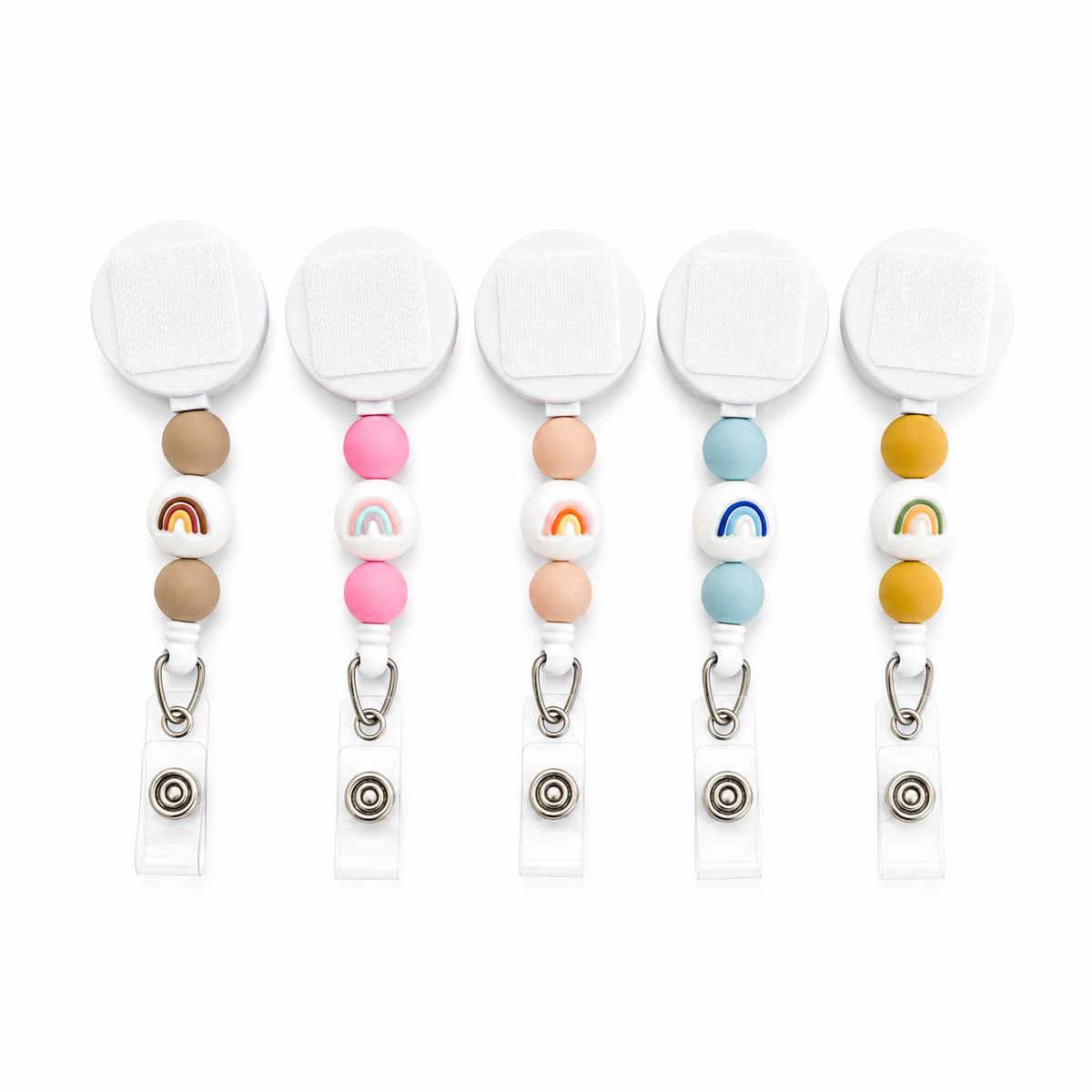 Interchangeable rainbow beaded badge reel featuring colorful silicone beads and rainbow accent bead in five pastel color variants with retractable badge holder.