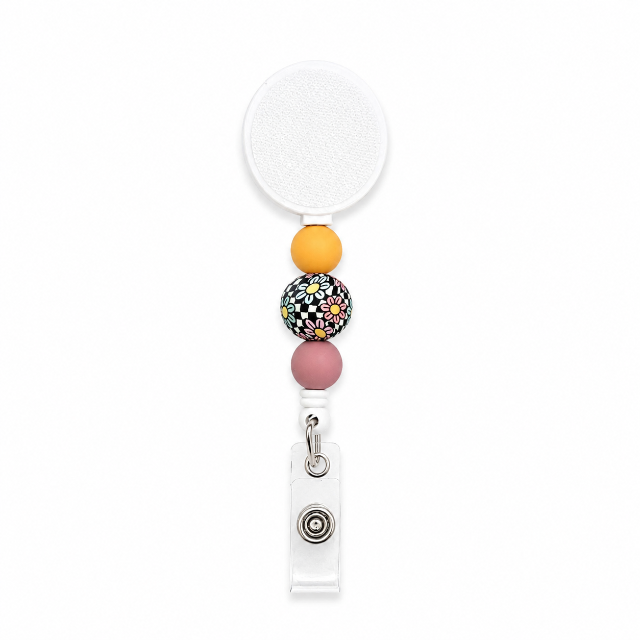 Retro daisy beaded badge reel with a white retractable reel, yellow and mauve silicone beads, and a colorful checkerboard floral accent bead for work.