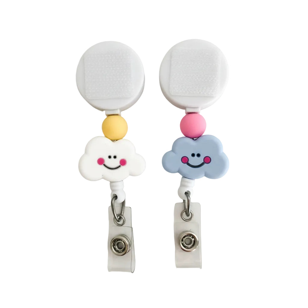 Smiley Cloud interchangeable badge reel featuring white and blue smiling cloud toppers with yellow and pink silicone beads, retractable beaded badge reel for nurses, teachers, and office staff.