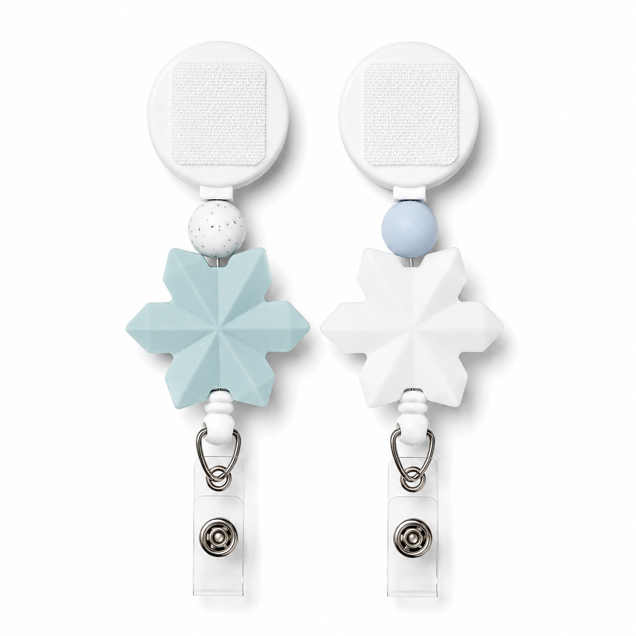 Snowflake interchangeable badge reel featuring a geometric white or blue snowflake charm with coordinating silicone beads, retractable badge holder, and winter-inspired design.