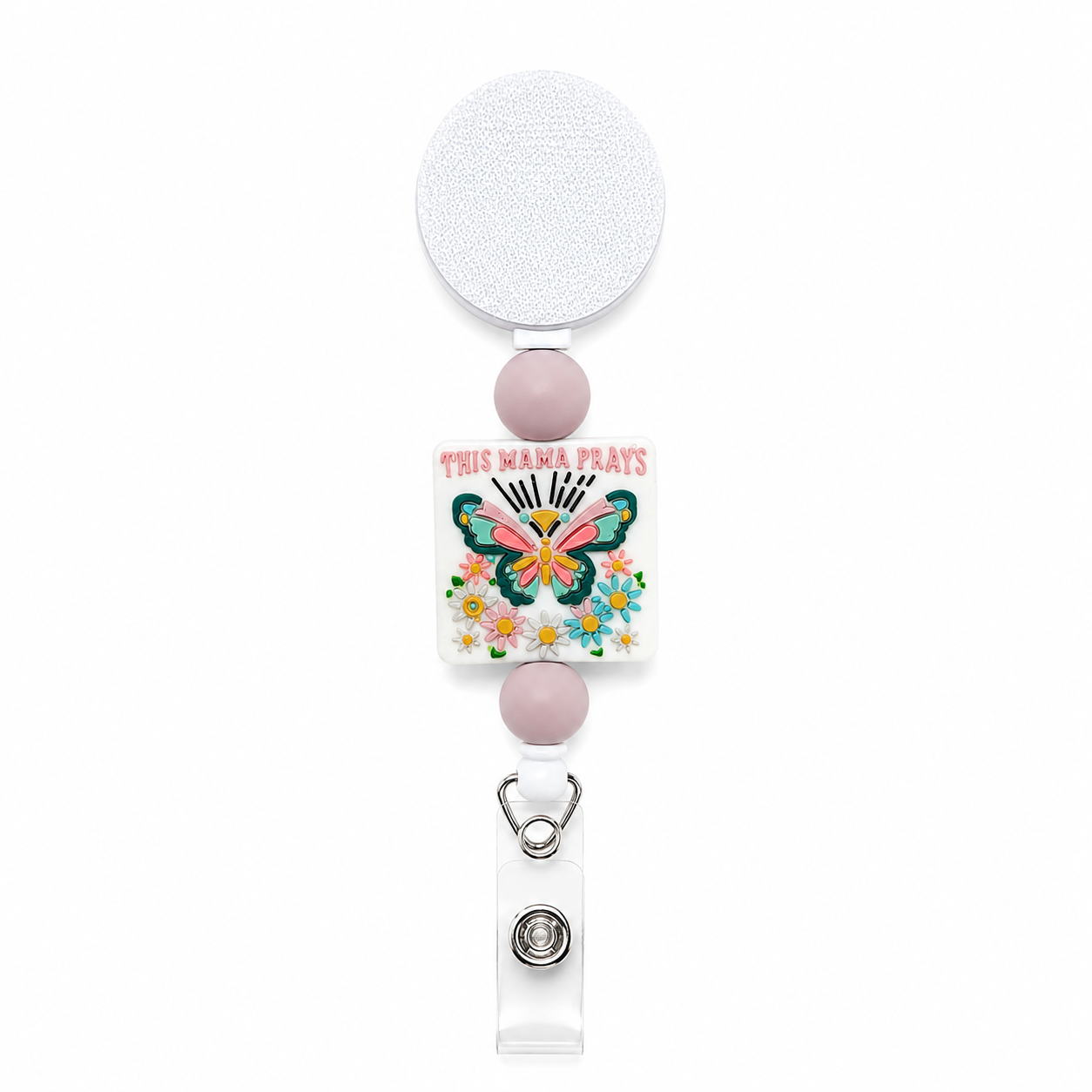 This Mama Prays butterfly badge reel featuring pink and teal floral artwork, mauve bead accents, a retractable reel, and clear badge holder attachment.