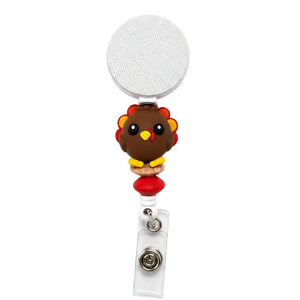 Thankful turkey interchangeable beaded badge reel featuring a cute turkey focal with red and natural bead accents on a white retractable badge reel.