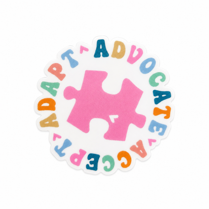 ADAPT ADVOCATE ACCEPT plastic add-on with pink puzzle piece and rainbow lettering, compatible with interchangeable badge reel bases for autism acceptance accessory style.