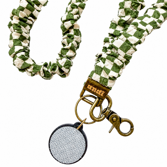 Andi x Lindsey Teaches Checkered Interchangeable Lanyard featuring a sage green and cream checkered fabric design, compatible with interchangeable hardboards and plastic add-ons.