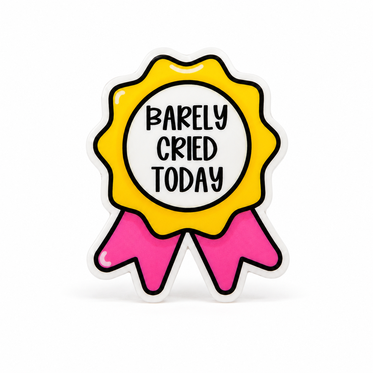 Plastic add-on featuring a yellow and pink award ribbon with the text "BARELY CRIED TODAY," compatible with interchangeable badge reel bases and perfect for workplace humor lovers.