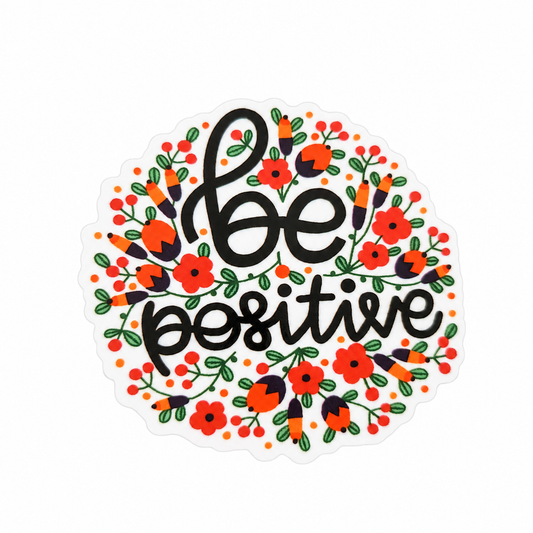 be positive plastic add-on with black lettering, red flowers, and green leaves, compatible with interchangeable badge reel bases for a positive floral accessory.