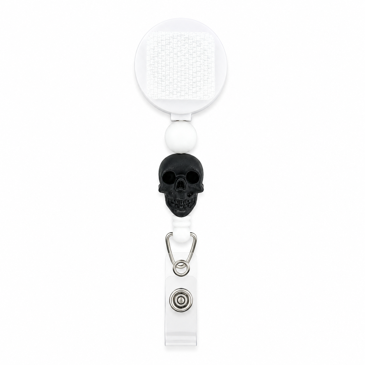 Black skull badge reel featuring a matte black skull bead, white silicone bead, and white retractable badge reel for nurses, healthcare workers, teachers, and gothic accessory lovers.