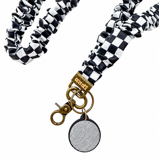 Black Checkerboard Interchangeable Andi Lanyard featuring a black and white checkerboard pattern, interchangeable badge lanyard compatible with interchangeable hardboards and plastic add-ons.
