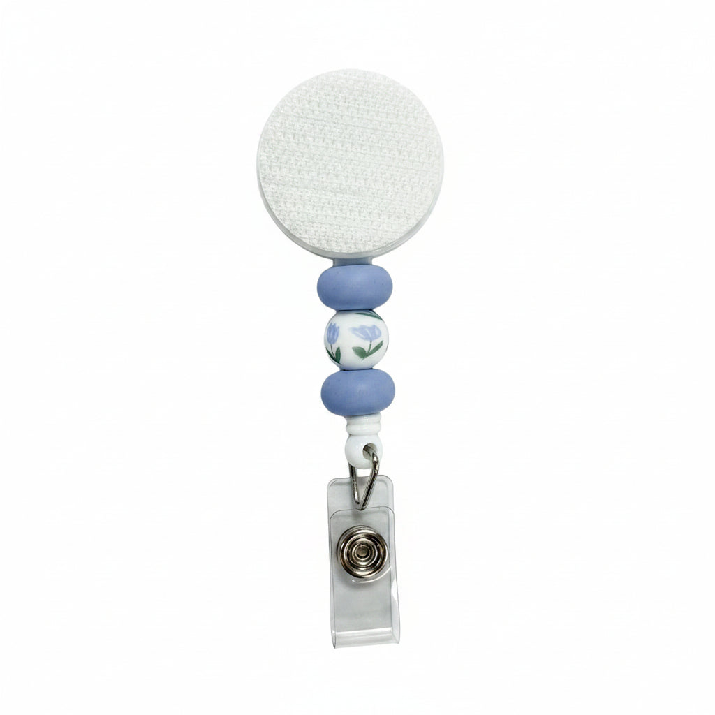 Blue floral badge reel featuring pastel blue silicone beads, a delicate blue flower accent bead, and a white retractable badge reel for nurses, teachers, and healthcare professionals.