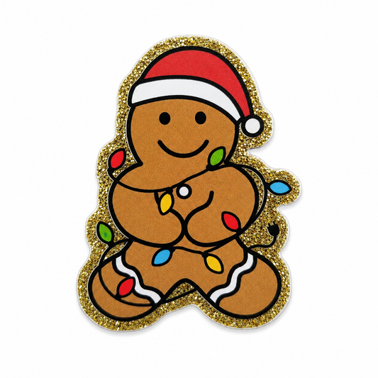 Christmas gingerbread cookie plastic add-on wearing a Santa hat and wrapped in colorful holiday lights, compatible with interchangeable badge reel bases and perfect for festive accessories.