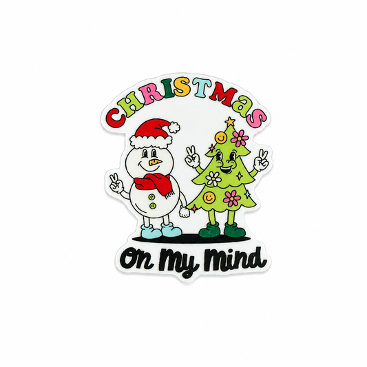 Christmas On My Mind plastic add-on featuring a cute snowman and smiling Christmas tree character, compatible with interchangeable badge reel bases, festive holiday accessory