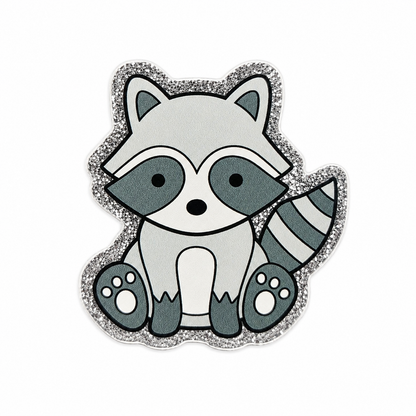 Cute raccoon plastic add-on with a glitter-style border, designed for compatible interchangeable badge reel bases and perfect for animal lovers and woodland-themed accessories.