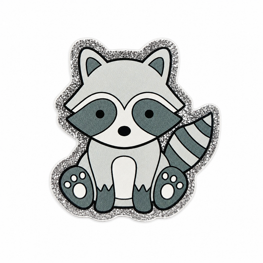 Cute raccoon plastic add-on with a glitter-style border, designed for compatible interchangeable badge reel bases and perfect for animal lovers and woodland-themed accessories.