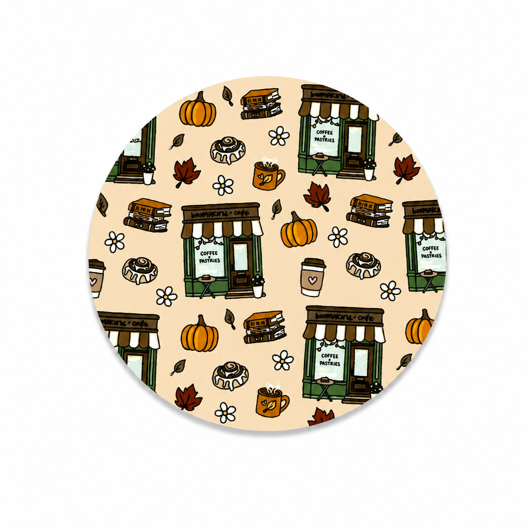 Hard board add-on featuring a cozy pumpkin café with coffee, pastries, pumpkins, books, autumn leaves, and flowers, compatible with interchangeable badge reel bases.