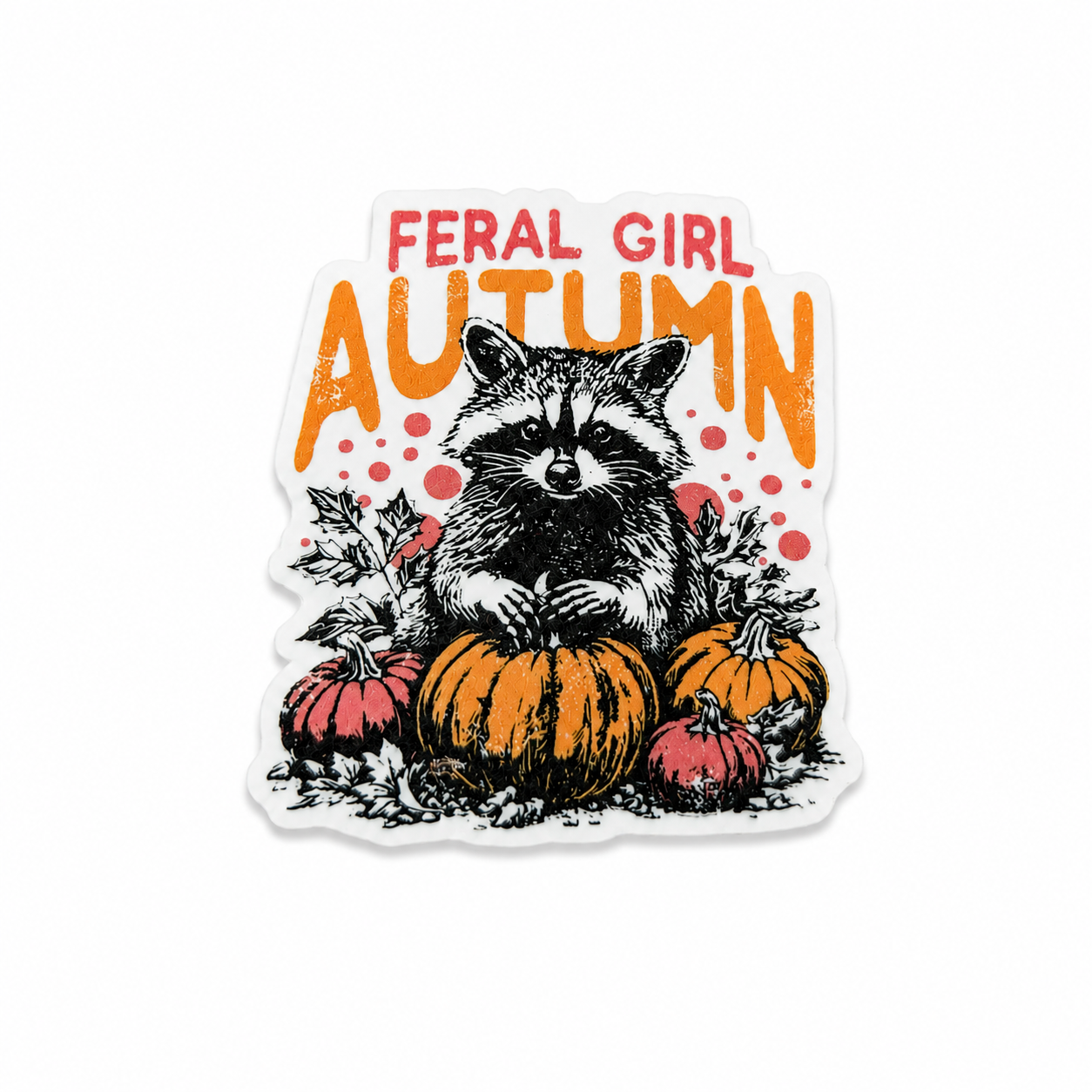 FERAL GIRL AUTUMN plastic add-on featuring a cute raccoon sitting among pumpkins in a fall-themed design, compatible with interchangeable badge reel bases, perfect for autumn lovers and animal enthusiasts