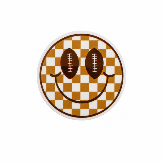 Football smiley face plastic add-on with football eyes and brown checkered design, compatible with interchangeable badge reel bases.