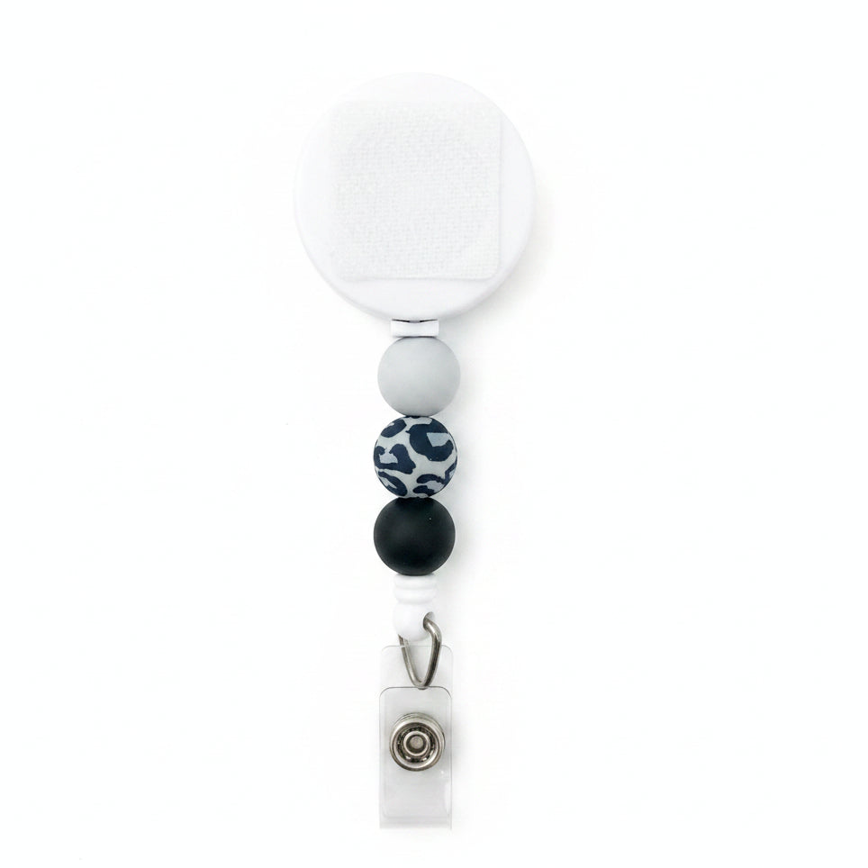 Gray leopard beaded badge reel with white retractable reel, light gray, black, and gray animal print silicone beads, interchangeable badge reel for work.