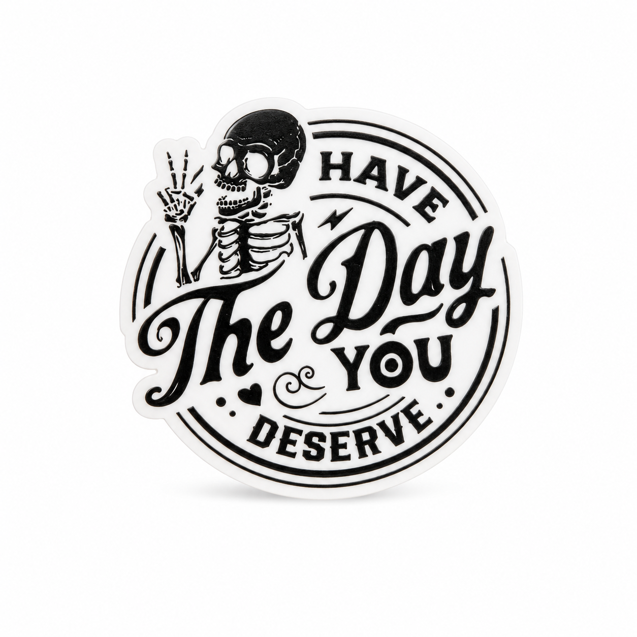 HAVE THE DAY YOU DESERVE plastic add-on with a skeleton holding up a peace sign, compatible with interchangeable badge reel bases for dark-humor fan