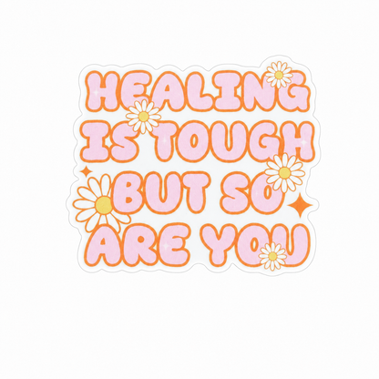 HEALING IS TOUGH BUT SO ARE YOU plastic add-on featuring pastel lettering and daisy flowers, compatible with interchangeable badge reel bases, inspirational mental health accessory and motivational badge topper.