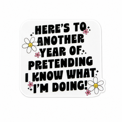 Here's To Another Year Of Pretending I Know What I'm Doing plastic add-on featuring bold text and daisy flowers, compatible with interchangeable badge reel bases, funny coworker gift and work accessory.