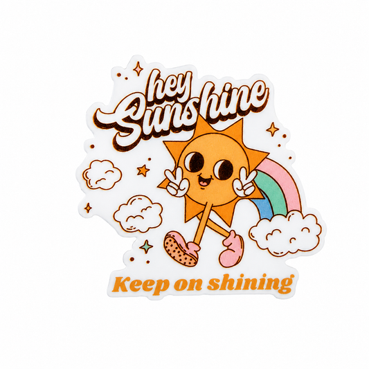 hey sunshine keep on shining plastic add-on featuring a smiling sun, rainbow, clouds, and stars, compatible with interchangeable badge reel bases.