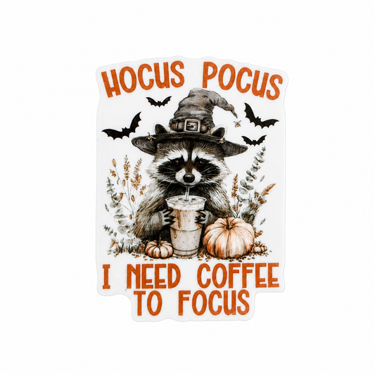 Plastic add-on featuring a raccoon in a witch hat holding coffee with the text "HOCUS POCUS I NEED COFFEE TO FOCUS," compatible with interchangeable badge reel bases and perfect for coffee lovers and Halloween fans.