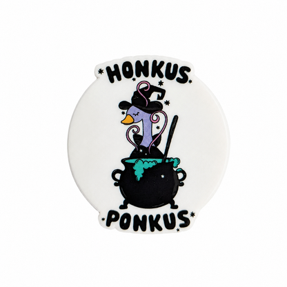 Honkus Ponkus plastic add-on featuring a witch goose in a bubbling cauldron, compatible with interchangeable badge reel bases, funny Halloween animal accessory
