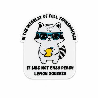 Plastic add-on featuring a raccoon wearing sunglasses holding a lemon with the phrase "IN THE INTEREST OF FULL TRANSPARENCY IT WAS NOT EASY PEASY LEMON SQUEEZY," compatible with interchangeable badge reel bases.