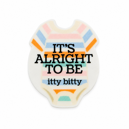 IT'S ALRIGHT TO BE itty bitty plastic add-on featuring a pastel baby onesie design compatible with interchangeable badge reel bases, NICU and preemie support accessory