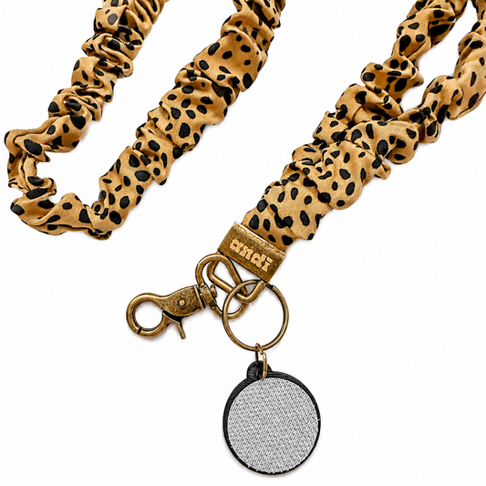 Jungle Cat Interchangeable Andi Lanyard featuring a tan and black leopard print fabric design, compatible with interchangeable hardboards and plastic add-ons.