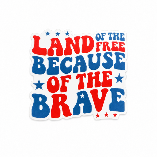 Plastic add-on featuring the phrase "Land of the Free Because of the Brave" in red, white, and blue patriotic lettering with stars, compatible with interchangeable badge reel bases.