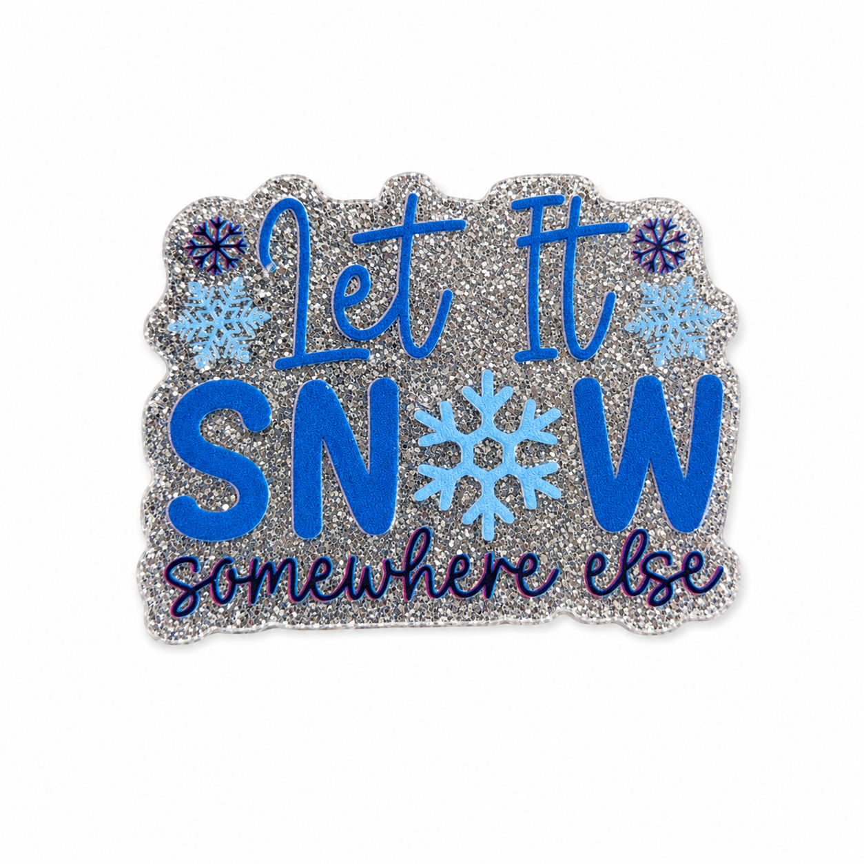 Let It SNOW Somewhere Else plastic add-on featuring blue snowflakes and silver glitter-inspired winter design, compatible with interchangeable badge reel bases and perfect for winter humor lovers.