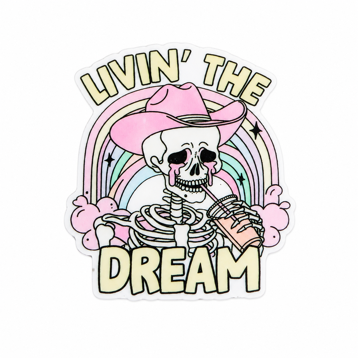 Plastic add-on featuring the phrase "LIVIN’ THE DREAM" with a skeleton wearing a pink cowgirl hat, holding a drink in front of a rainbow, compatible with interchangeable badge reel bases.