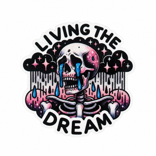 Living The Dream plastic add-on featuring a melting skeleton with stars and clouds, compatible with interchangeable badge reel bases, gothic humor accessory