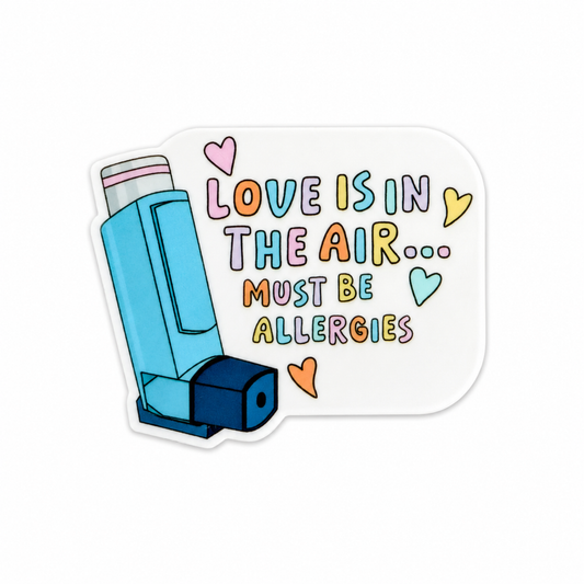 Love Is In The Air Must Be Allergies plastic add-on featuring a blue inhaler, colorful hearts, and funny respiratory humor, compatible with interchangeable badge reel bases.