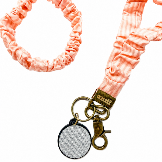 Lovely Stripe Interchangeable Andi Lanyard featuring a blush pink striped scrunchie-style fabric design, compatible with interchangeable hardboards and plastic add-ons.