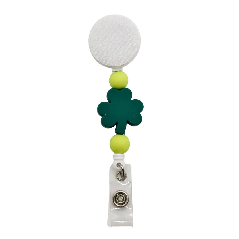 Lucky shamrock interchangeable badge reel featuring a green four-leaf clover focal with lime green silicone beads on a white retractable badge reel.